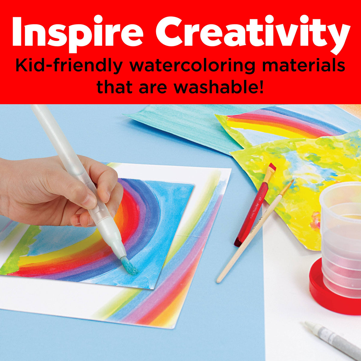 A child uses a water brush from the Young Artist Learn to Watercolor Art Set for Kids by Faber-Castell / Creativity for Kids to paint a colorful rainbow on paper, exploring various watercolor techniques. Nearby are the set’s washable, kid-friendly watercolor materials, a cup of water, and completed rainbow paintings. Text above reads: Inspire Creativity – Kid-friendly watercoloring materials that are washable!.
