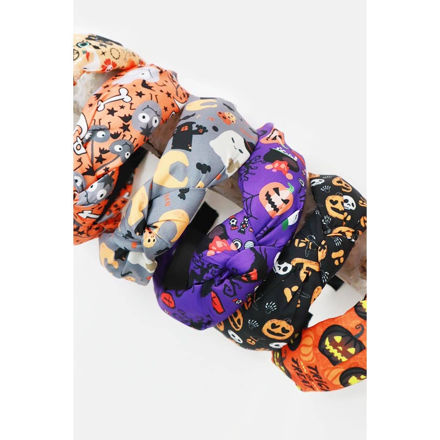 Five Love and Repeat Halloween Theme Headbands featuring knotted designs with various patterns, including ghosts, pumpkins, and skeletons.