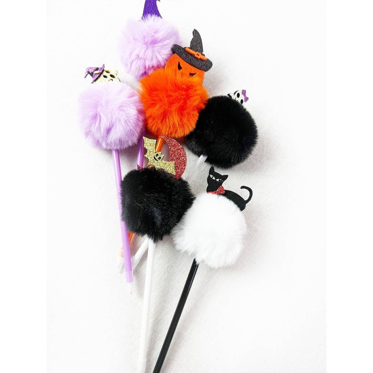 Five Halloween Theme PomPom Pen writing instruments topped with fuzzy pom-poms featuring pumpkin, black cat, ghost, and witch hat icons.