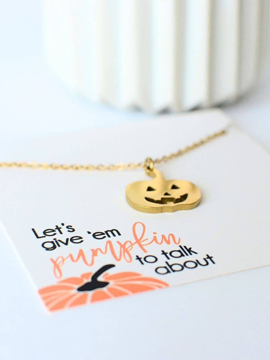 Gold Pumpkin Necklace on a display card that reads Lets give em pumpkin to talk about.