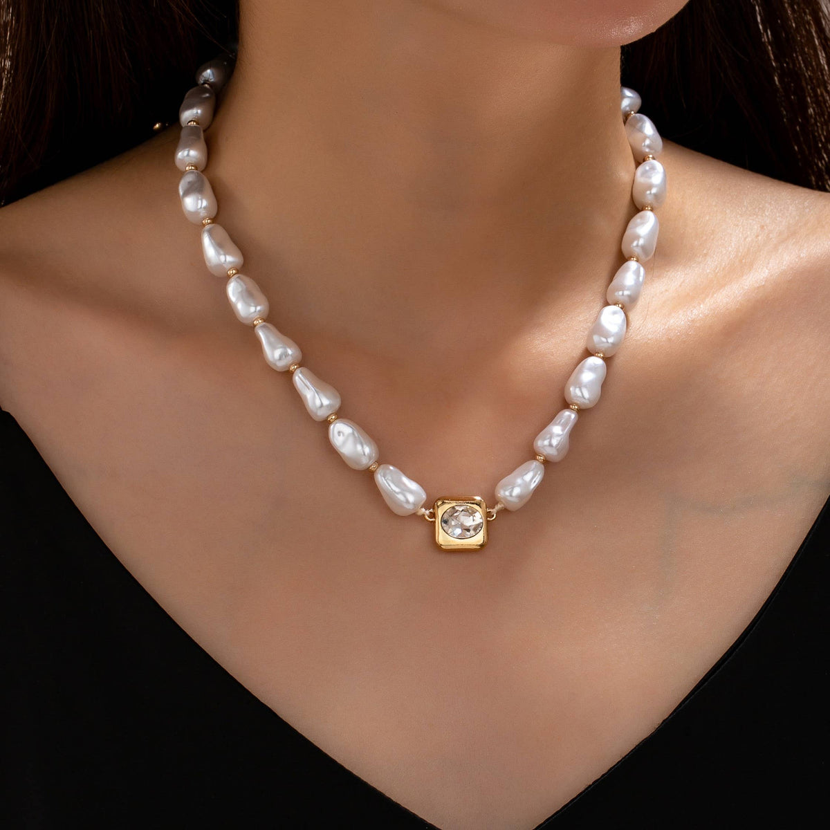 JOSSLYN by wall to wall Baroque Pearl & Bezel-Set Crystal Necklace featuring irregular white pearls, small gold spacers, and a square gold pendant with a central clear crystal.