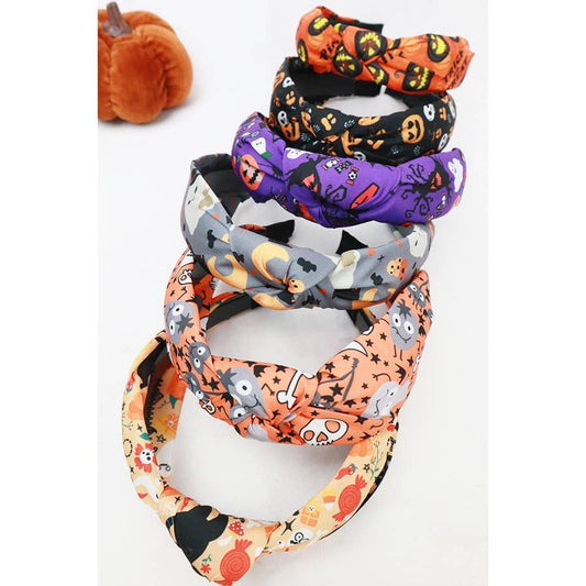 Love and Repeat Halloween Theme Headband set featuring a stack of four fabric headbands with pumpkin, ghost, and candy prints.