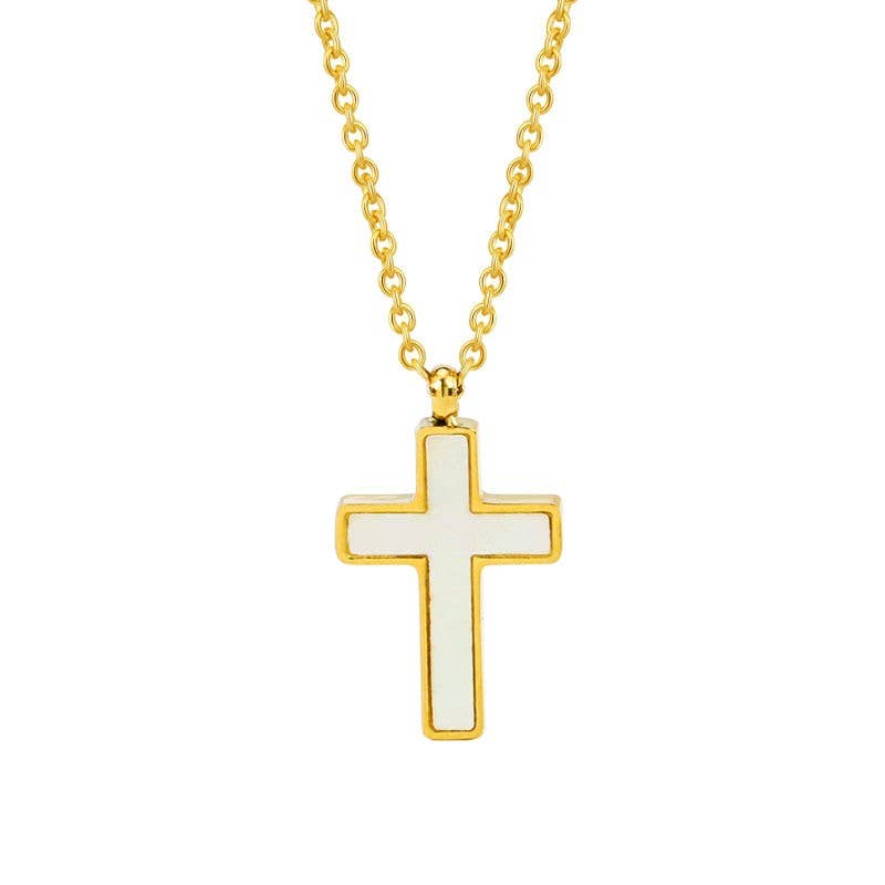 The Tarnish Free Cross Necklace by JOSSLYN by wall to wall, featuring a gold-outlined white cross pendant on a gold chain, is displayed centered on a plain white background.