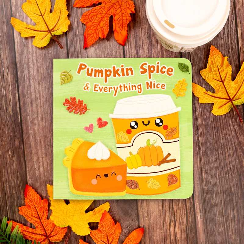 Pumpkin Spice & Everything Nice by Dienesa Le, published by Simon & Schuster, is a children’s book featuring adorable cartoon illustrations of pumpkin pie and a pumpkin spice drink, set among autumn leaves on a wooden surface.
