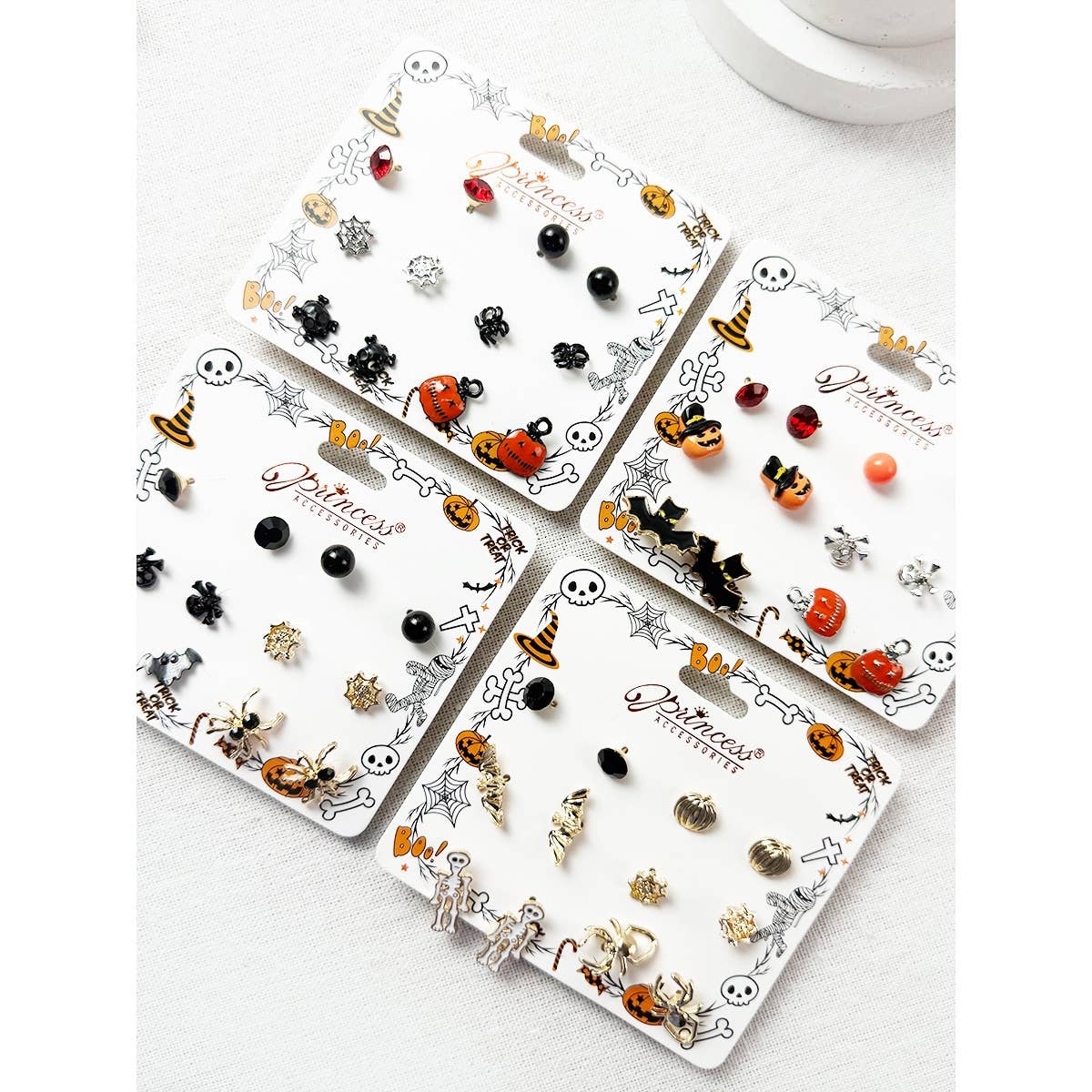 Four earring cards from the Cute Halloween Theme Earring Set by Love and Repeat featuring assorted pumpkins, ghosts, bats, spiders, and skeletons.