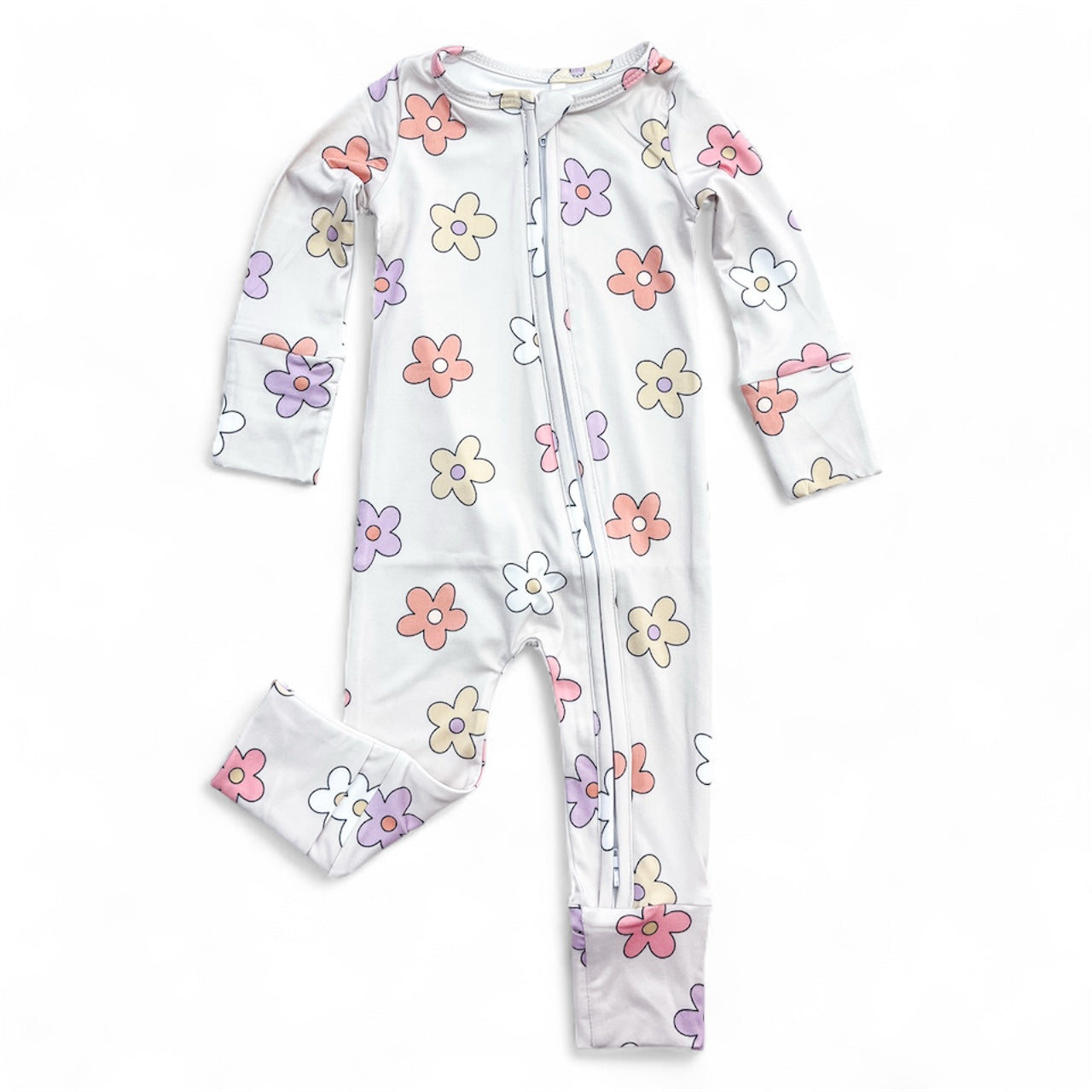The Groovy Garden Zippy by Tiny Tot Bundles is a white, long-sleeve baby jumpsuit featuring a vibrant pink, purple, orange, and yellow floral print with a front zipper from neck to leg.
