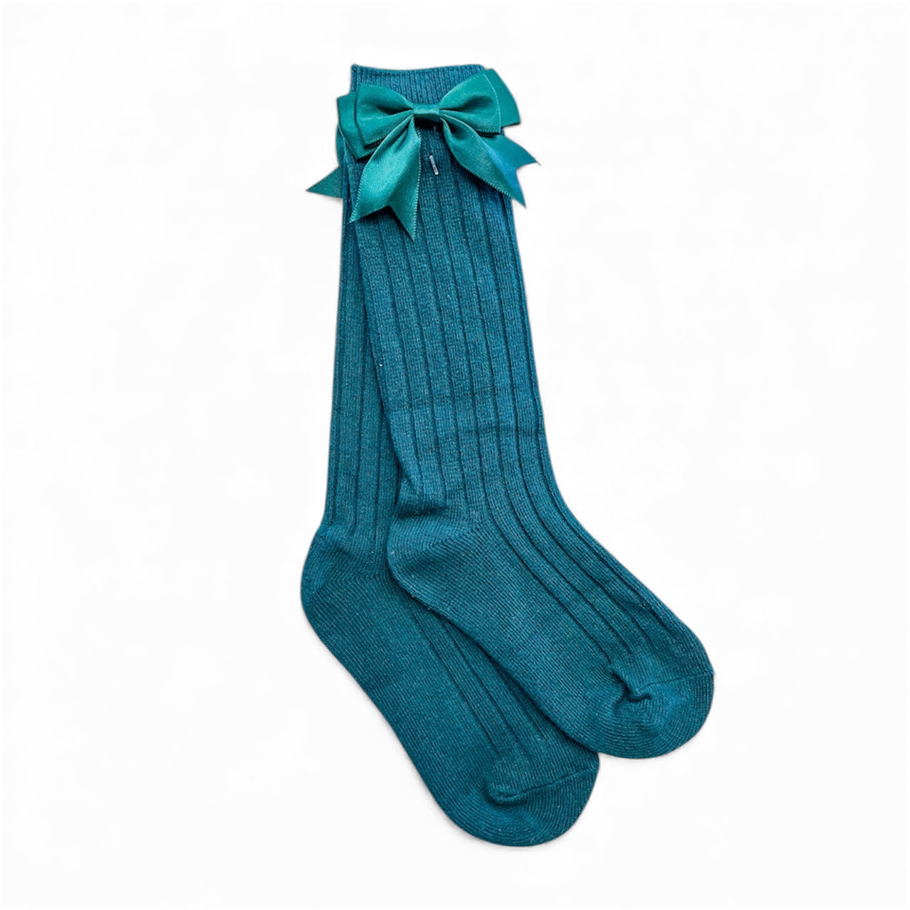 Tiny Tot Bundles' Pretty Bow Ribbed Socks in teal feature a ribbed knee-high design and a large matching bow on one sock, shown neatly crossed against a plain white background.