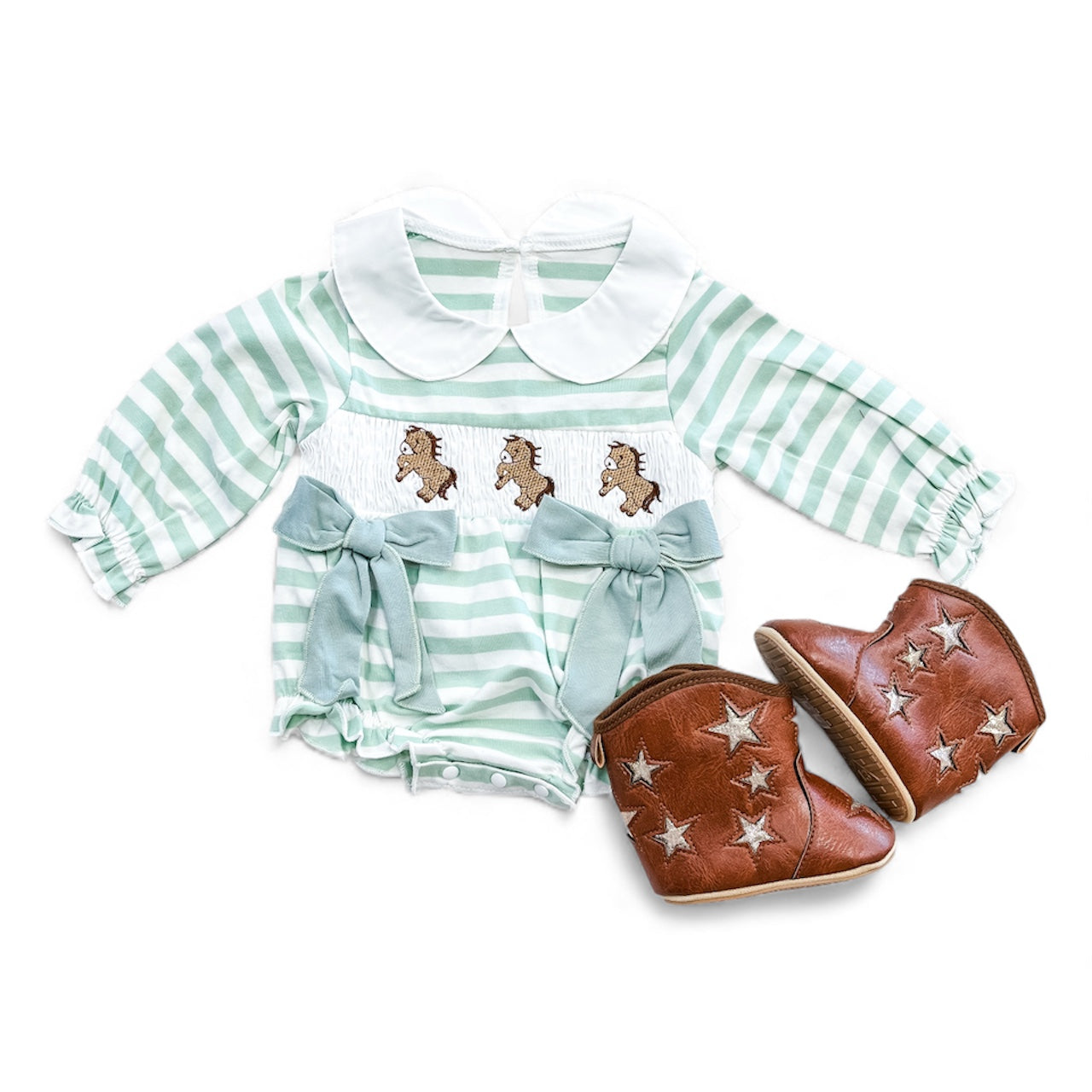 The Tiny Tot Bundles Little Horse Stripe Bubble features green and white stripes, a white collar, horse embroidery, and two blue bows—paired with brown baby cowboy boots adorned with white stars.