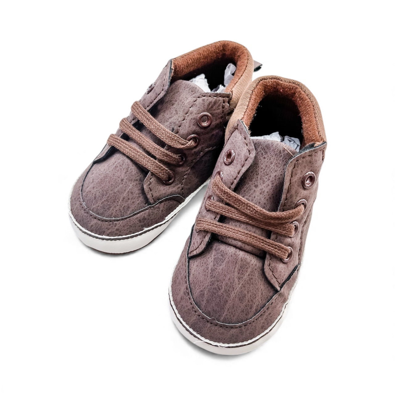 The Mini Explorer High Tops by Tiny Tot Bundles: brown baby shoes featuring laces, white soles, and light brown inner lining, displayed on a white background.