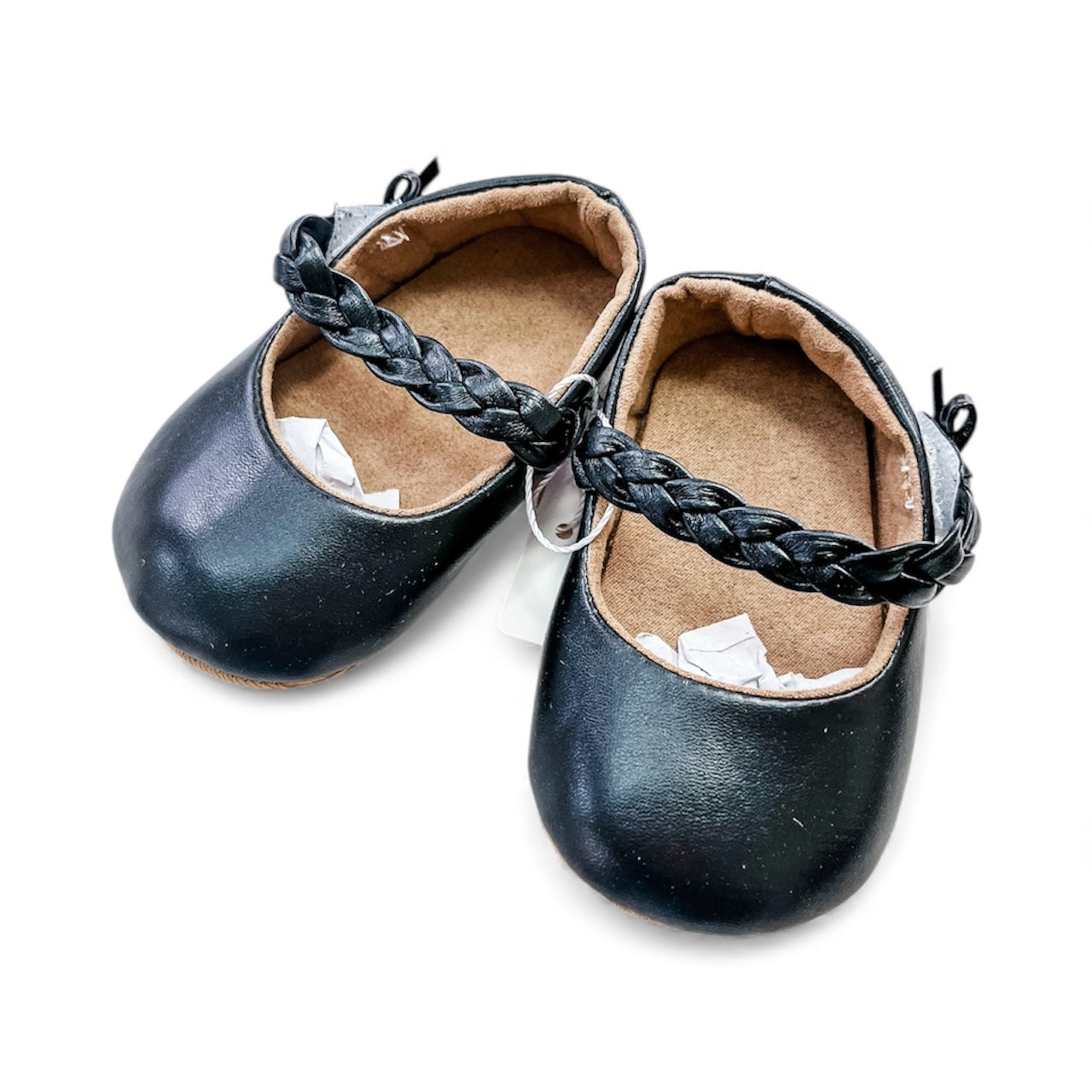 Tiny Tot Bundles Braided Baby Mary Janes: small black baby shoes with braided straps and brown insoles, displayed on a white background.