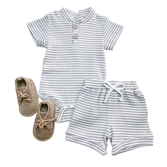 The Grayson Stripe Set by Tiny Tot Bundles includes a short-sleeved striped romper with buttons, drawstring shorts, and beige corduroy lace-up shoes, all displayed on a white background.