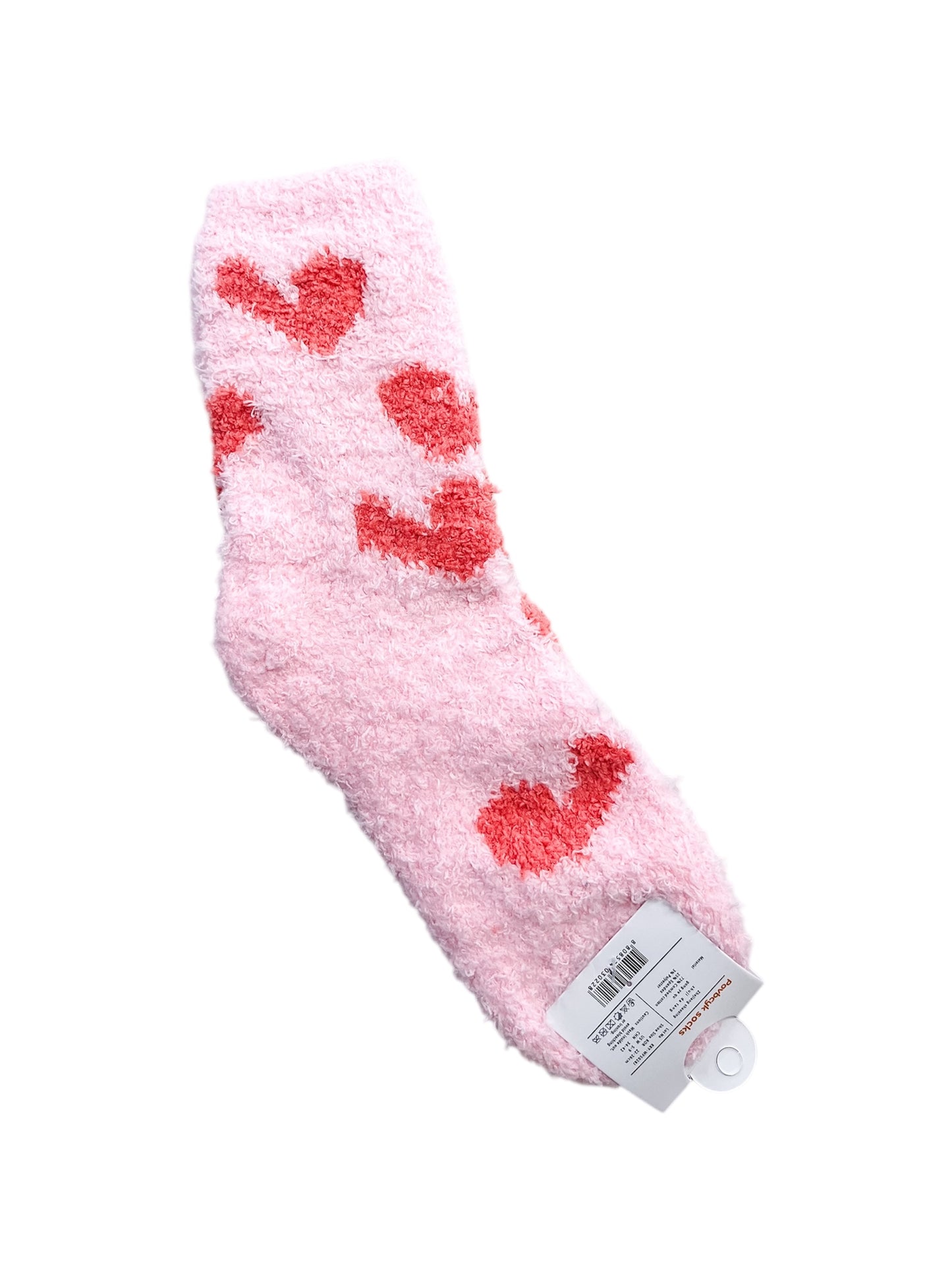 A single Sweetheart Lounge Sock by love & repeat in fuzzy pink with red heart patterns, featuring a retail tag at the bottom.