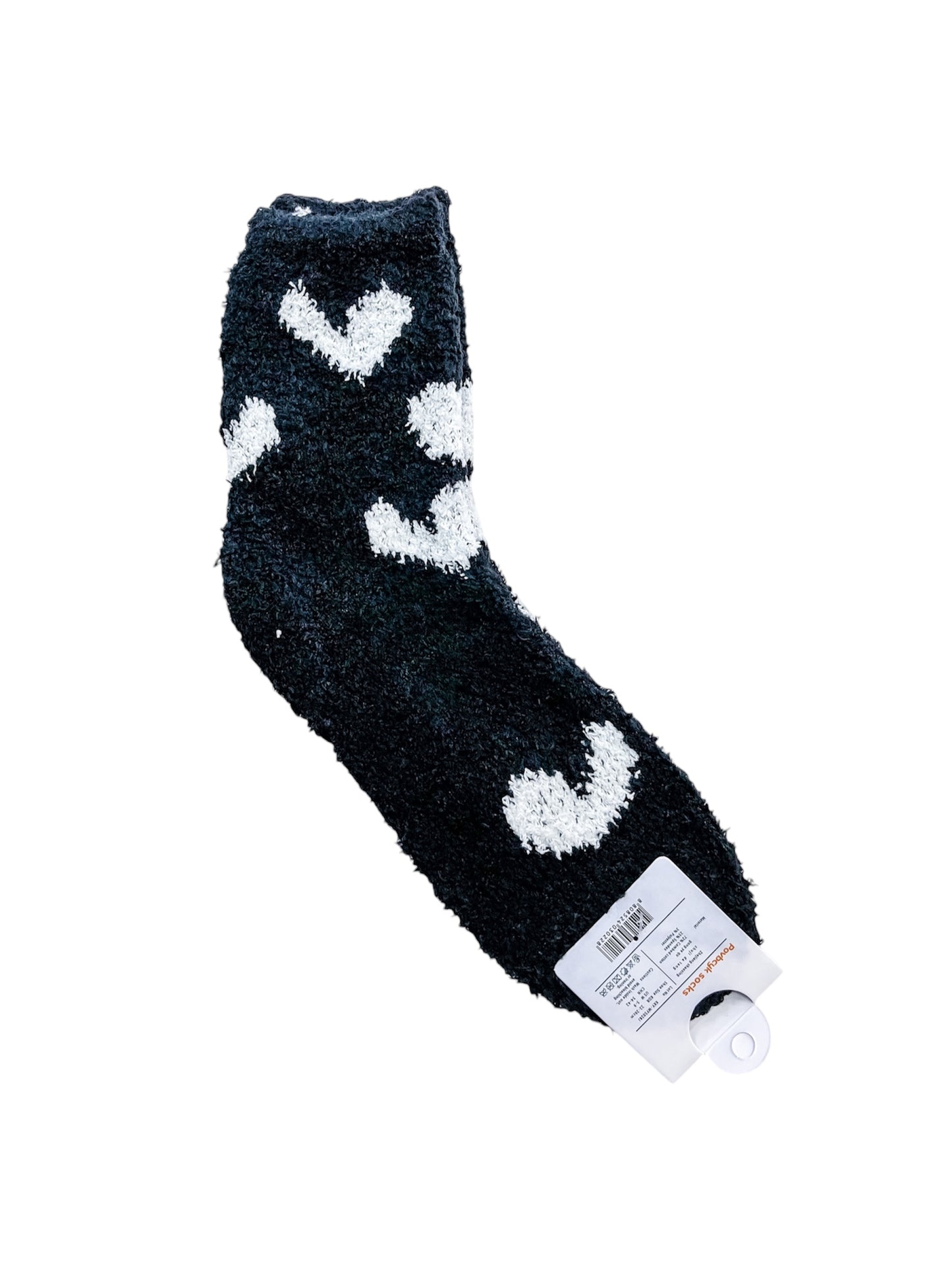 The love & repeat Sweetheart Lounge Socks are single black fuzzy socks with white heart patterns, shown with the retail tag attached to the toe.