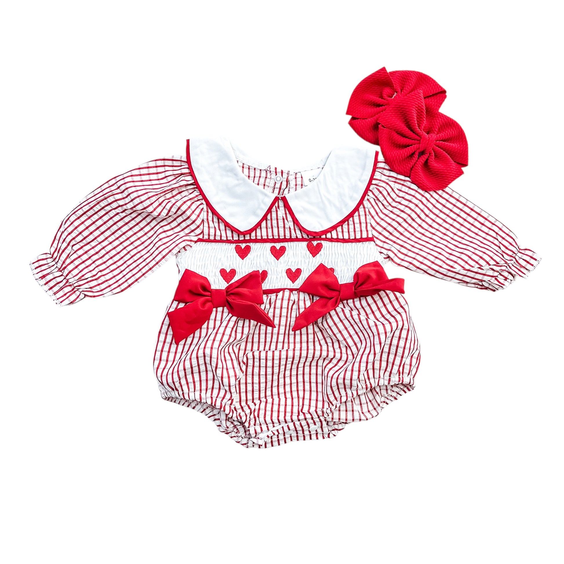 The Sweetheart Gingham Bow Romper by Tiny Tot Bundles features red and white stripes, a white collar, red hearts, two red waist bows, and comes with a matching large red hair bow.