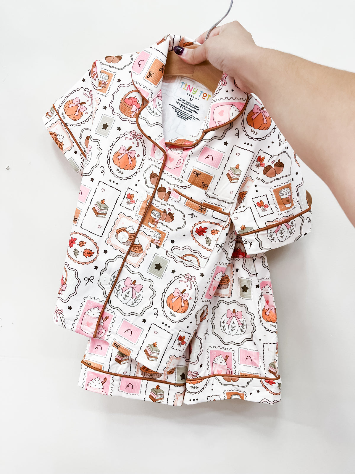 Fall Favorites Short Jammies Set consisting of a short-sleeved pajama set with a repeating pattern of pumpkins, coffee cups, and fall treats in postage stamp-style frames.