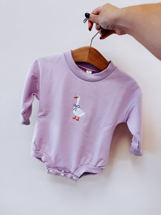 Light purple long-sleeved Purple Goose Embroidered Bubble romper featuring an embroidered goose wearing a ribbon.