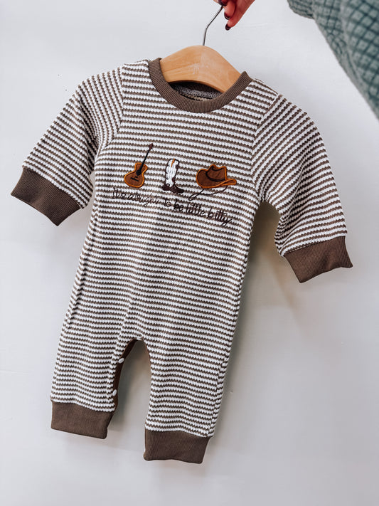 Little Bitty Long Sleeve Romper with brown and white horizontal stripes, featuring embroidered icons of a guitar, a cowboy boot, and a cowboy hat above the text its alright to be little bitty.