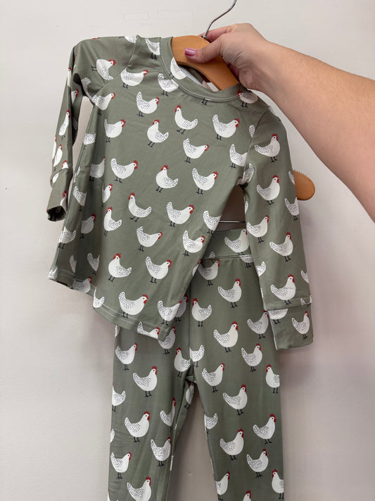 Cluckin’ Cute Two Piece Set in sage green with a long-sleeved shirt and matching pants featuring an all-over white chicken pattern.