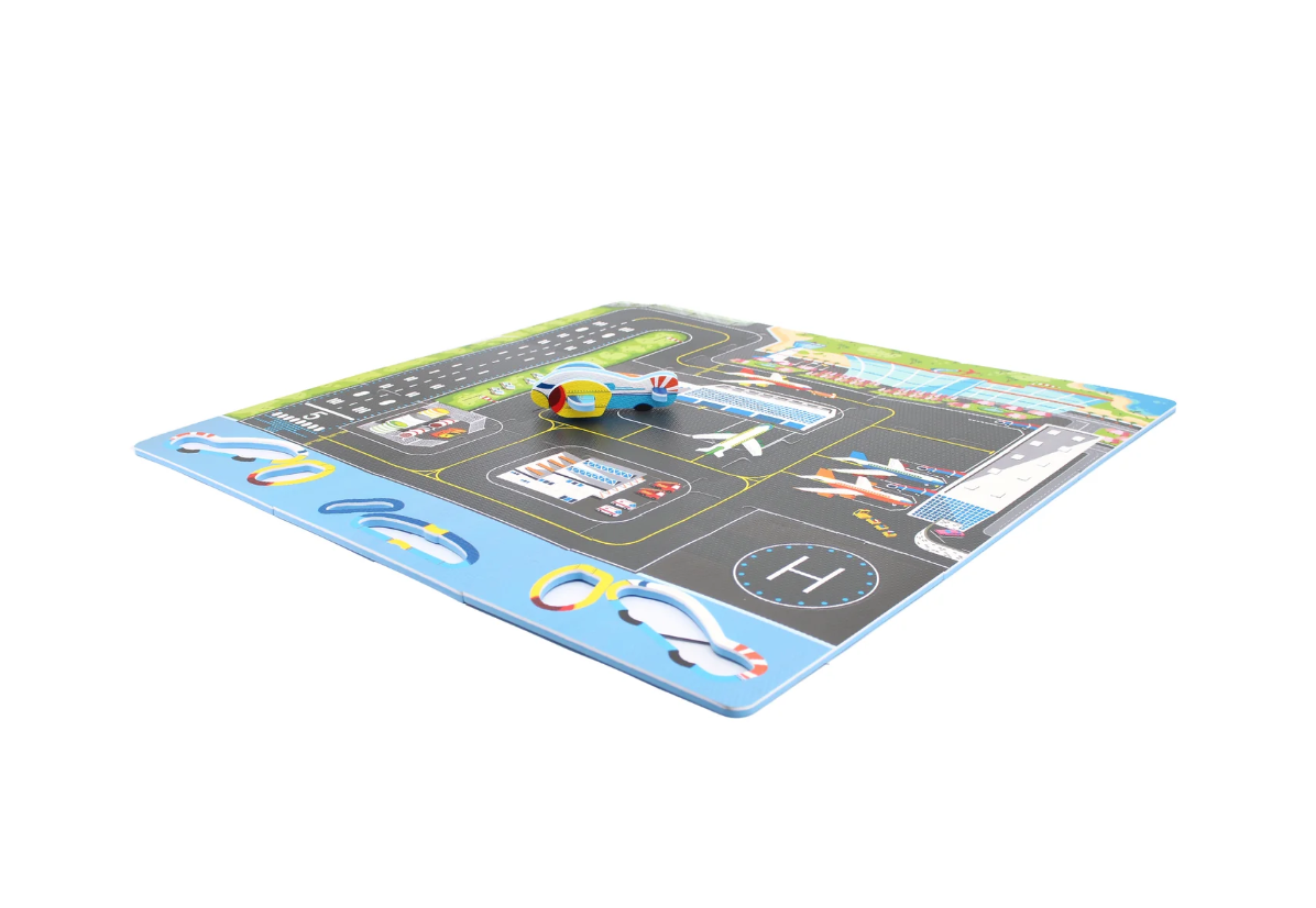 The Triaction Plane & Airport Play Mat features colorful runways, parking spaces, a helipad, and includes small toy vehicles like an airplane and helicopter placed on top.