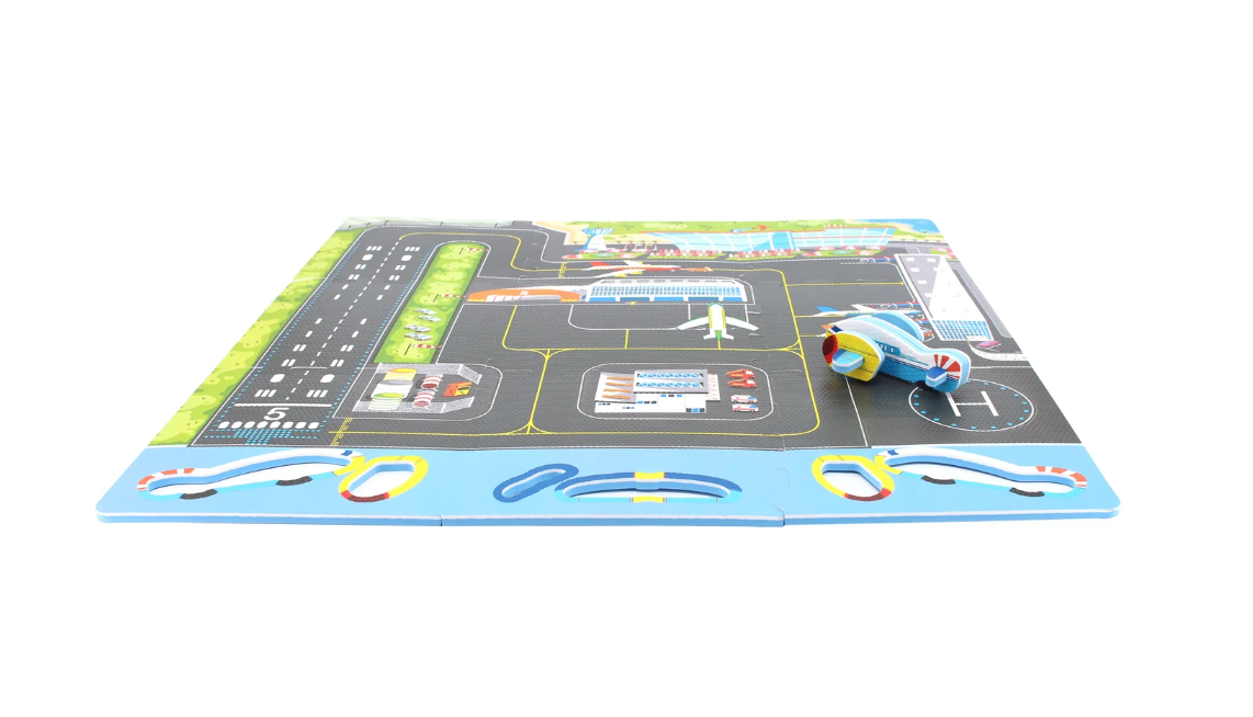 The Triaction Plane & Airport Play Mat features colorful airport-themed illustrations, including runways, taxiways, buildings, and comes with a small blue toy airplane positioned on the mat.