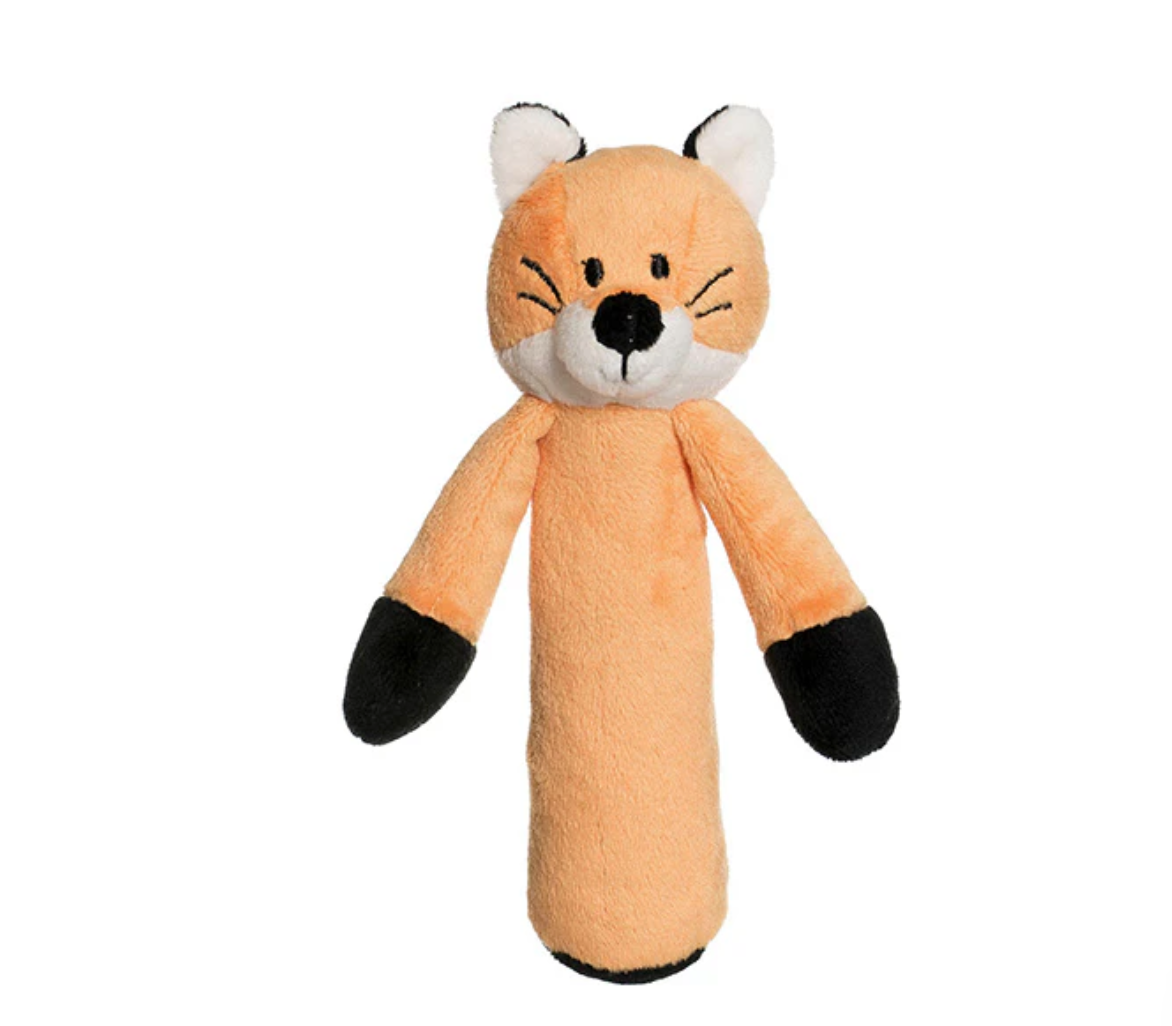 The Triaction Fox Rattle is a plush orange and white fox toy with black ears, paws, and nose, shown standing upright on a plain white background.