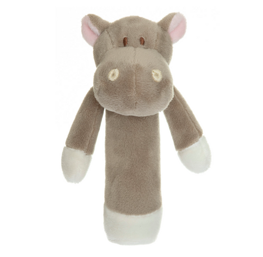 The Triaction Hippo Rattle is a plush brown and white toy with a long cylindrical body, round snout, small ears, and stitched eyes, shown standing upright against a white background.