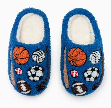 Living Royal's All-Star Cozy Slippers feature a blue fuzzy exterior, soft white interior, and embroidered images of basketballs, soccer balls, volleyballs, baseballs, and footballs.