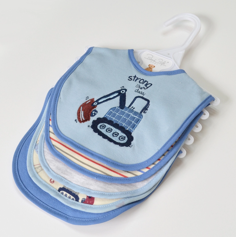 The Lollipop Dreams Mighty Machines Bib Set includes colorful, patterned bibs with blue trim on a hanger. The top bib features a blue excavator and the phrase "strong like daddy.