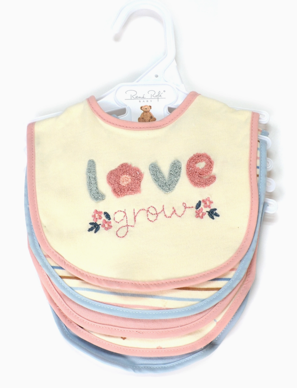 The Love & Grow Bib Set by Lollipop Dreams includes soft baby bibs on a hanger, with the top bib reading “love grow” and featuring embroidered flowers. The bibs have pastel pink and blue borders.