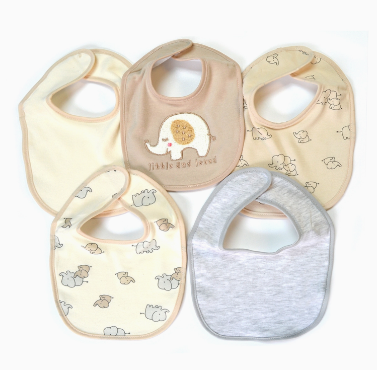 The Lollipop Dreams Little & Loved Bib Set includes five pastel baby bibs in cream, beige, and gray with animal prints. One features an embroidered elephant and the text "little and loved.