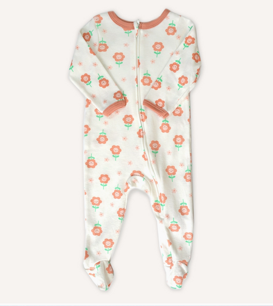 The Lollipop Dreams Peachy Petals Zip Footie is a white baby sleeper with pink trim, a front zipper, and a pink flower and green stem pattern.