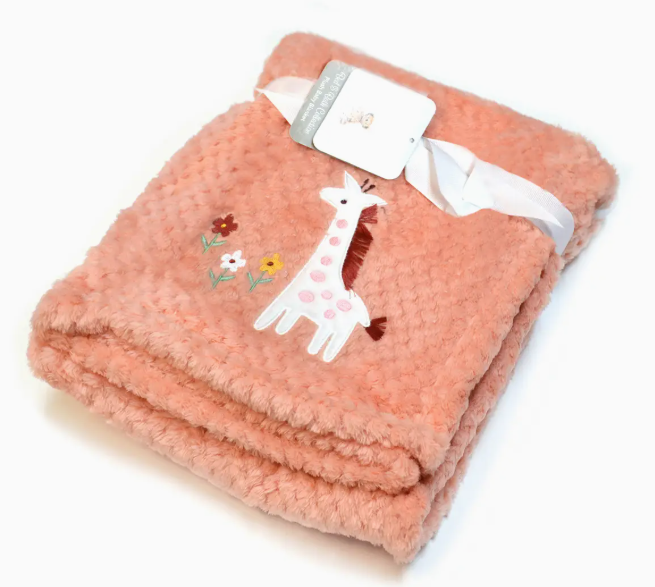 The Giraffe Garden Snuggle Blanket by Lollipop Dreams is a folded pink textured baby blanket with an embroidered white and pink giraffe and small flowers, tied with a white ribbon and tag.