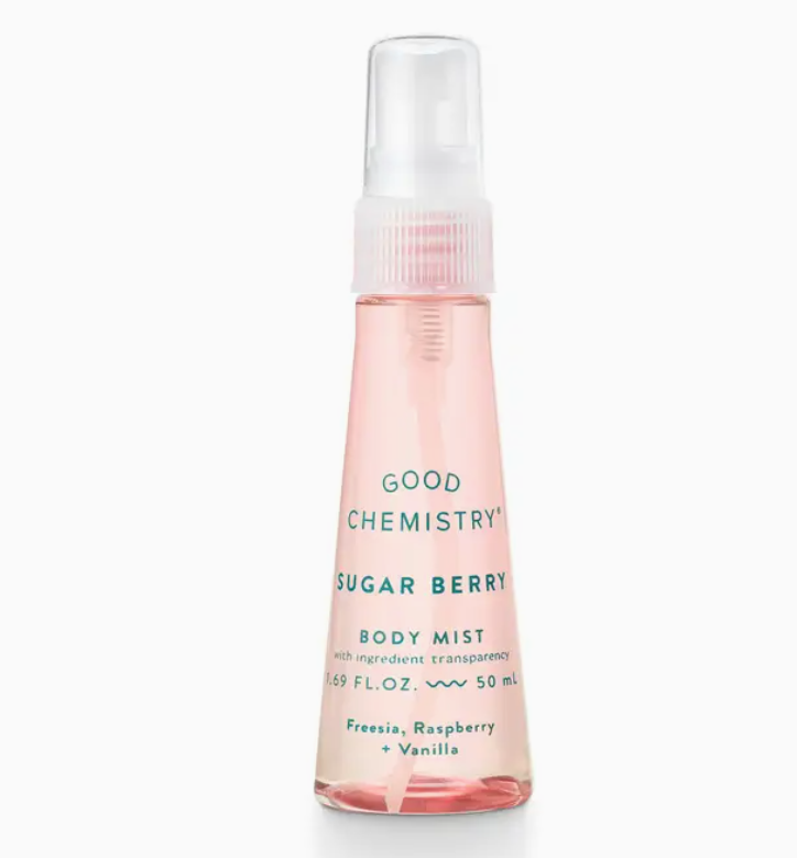 The Good Chemistry Sugar Berry Mini Body Mist, in a pink 1.69 fl. oz. (50 mL) spray bottle, features freesia, raspberry, and vanilla scent notes for a delightful fragrance experience.