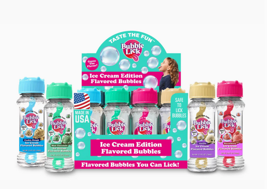 A display of Toy Smith’s Bubblelick™ Ice Cream Flavors in colorful bottles—Cookie Dough, Cotton Candy, Birthday Cake, and Caramel—with a “Flavored Bubbles You Can Lick!” sign; ideal as party favors.