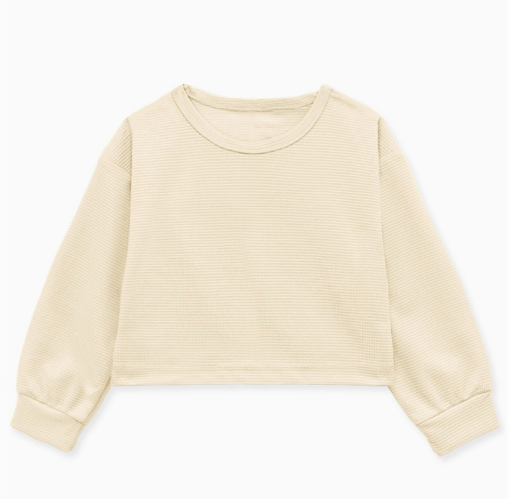 The Cream Sporty Long Sleeve by Cutie Patootie is a beige, crew-neck, cropped waffle-knit shirt with cuffed long sleeves, displayed flat on a white background.