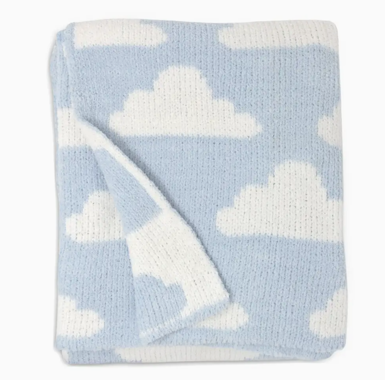 The living textiles Chenille Baby Blanket - Blue Clouds features a soft, cozy knit with a light blue background and white cloud patterns. One corner is flipped over, showing the same plush cloud design on the reverse side.