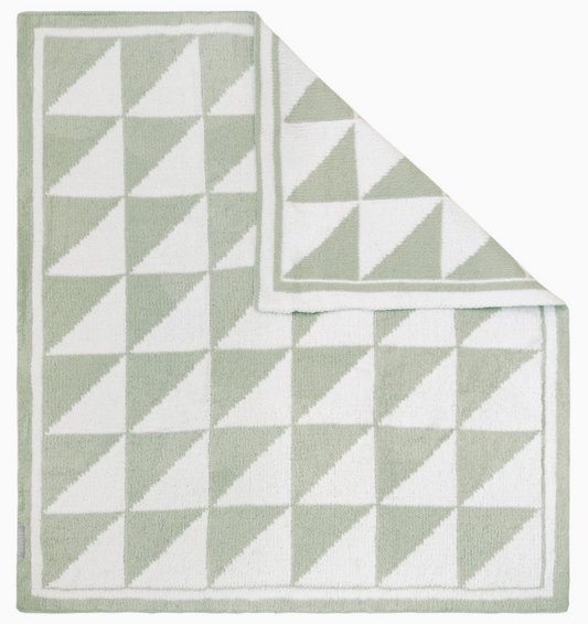 The living textiles Chenille Baby Blanket - Sage Triangle features a geometric pattern of alternating sage green and white triangles and is shown partially folded to reveal the reverse side.