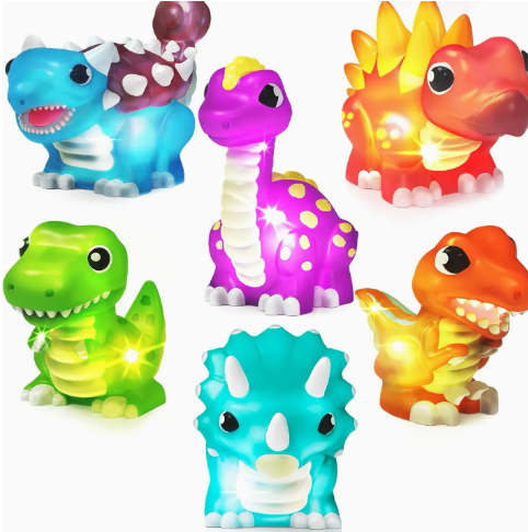 TubWorks Tub Works® Dinos™ Dinosaur Light Up Bath Toys, 6 Pack features six colorful, glowing cartoon dinosaurs—a blue triceratops, green T-Rex, orange raptor, purple brontosaurus, red stegosaurus & blue dino with white spikes.