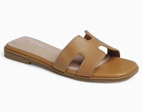 The Caramel Coast Slides by Fashion Emporio are tan flat sandals with a wide, open toe strap featuring cut-out details, a slightly squared toe, and a minimalist design.