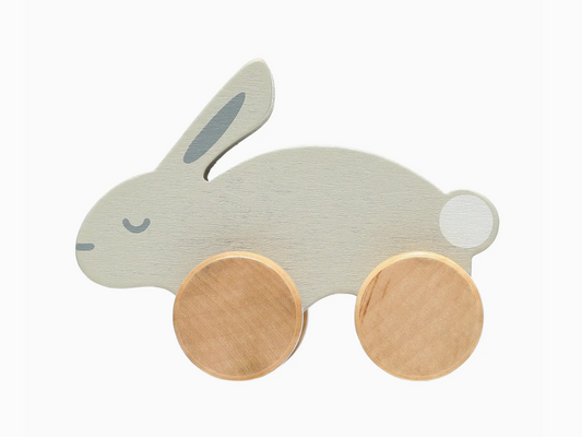 The PearHead Wooden Toy Bunny is a gray rabbit with painted facial features and two large round wooden wheels on each side.