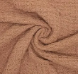 Close-up of crover 100% Cotton Waffle Baby Blanket in Cinnamon, highlighting its textured light brown waffle weave fabric arranged in a spiral at the center.