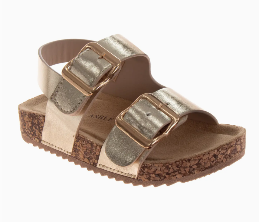 The Golden Sunshine Sandals by Josmo Shoes Inc feature two wide gold metallic straps with large gold buckles and a cork-textured platform sole with a ridged bottom.
