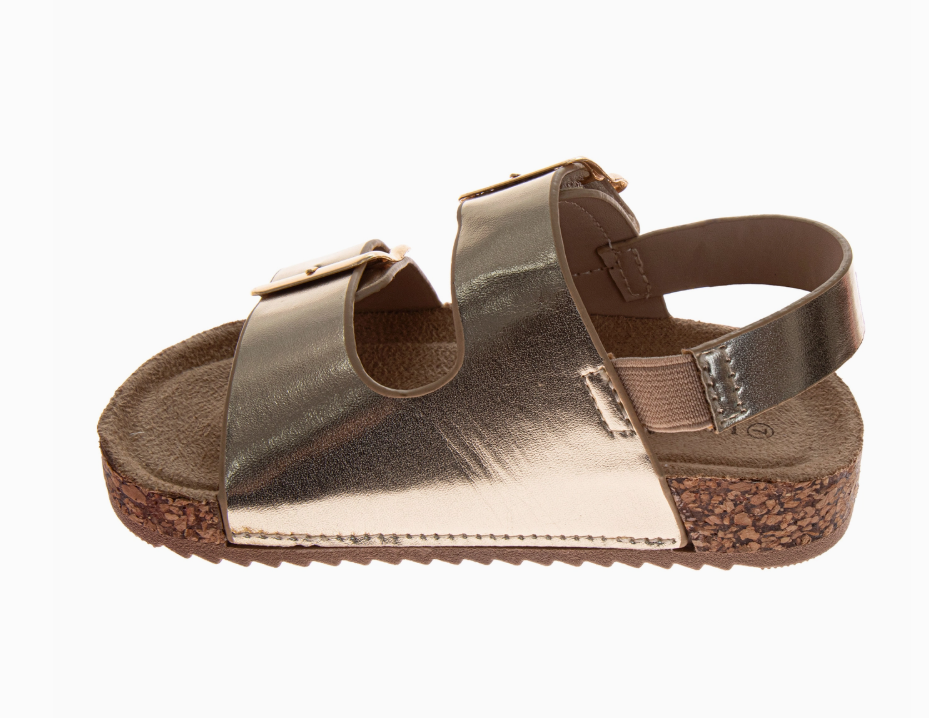 The Golden Sunshine Sandals by Josmo Shoes Inc feature a metallic gold finish, cork sole, two adjustable top straps, and an elastic back strap, offering comfort and style for casual wear.