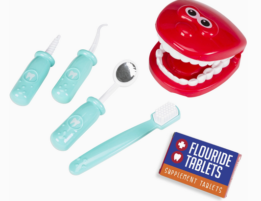 The Toy Smith My Play Dentist Set includes a red plastic mouth model, toothbrush, dental mirror, two dental tools, and a Fluoride Tablets Supplement Tablets box, all displayed on a white background.