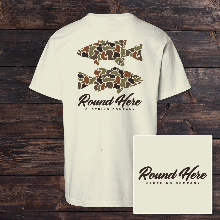 The Old North State Southern Water Youth tee: white t-shirt with two camouflage fish silhouettes above "Round Here Clothing Company" in script. Inset displays a close-up of the Round Here logo on a plain background.