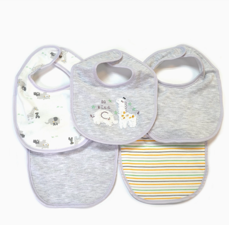 The Lollipop Dreams Be Kind Llama Bib Set includes four bibs: animal print, embroidered animals with "be kind" text, solid light gray, and yellow-blue-green stripes. Each features light gray trim.