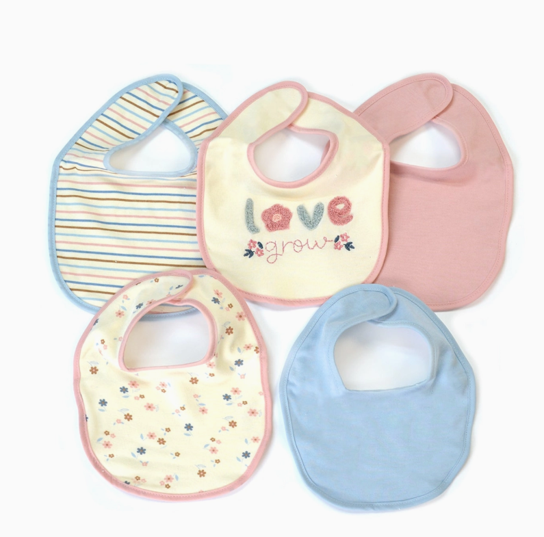 The Sweetheart Baby Bib Set by Lollipop Dreams includes five pastel bibs—striped, floral, solid blue, pink, and a cream one with “love grow” embroidery and small flowers—all overlapping on a white background.