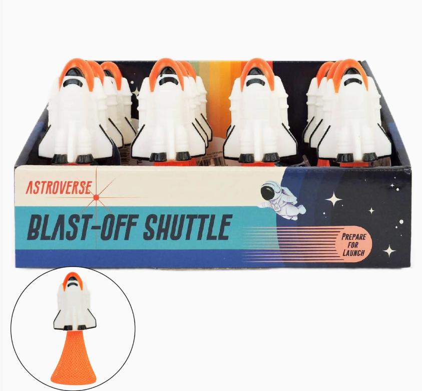 A Toy Smith Astroverse Blast-Off Shuttle display box holds toy shuttles with white bodies and orange fins. The inset highlights a shuttle angled upward, showcasing its blast-off launch action.