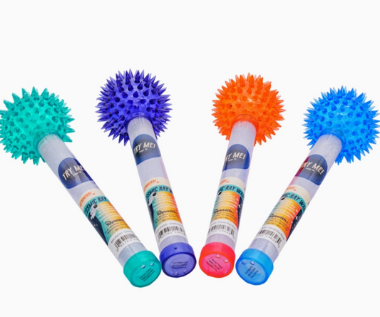 Four Toy Smith Astroverse Cosmic Ray Wands are arranged diagonally, each a different color—green, blue, purple, and orange—with matching spiky balls on top and product labels on their handles.