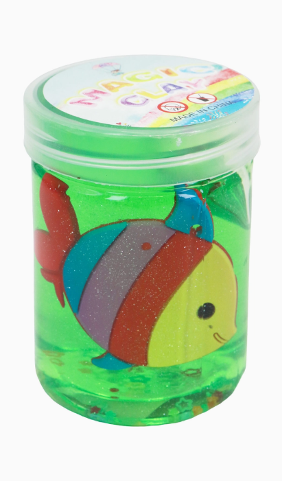 A clear Capzone Marine Sea Animal Slime Mini Jar holds bright green slime and a colorful, smiling toy fish with red, blue, yellow, and purple stripes. The round lid features the Magic Clay label.